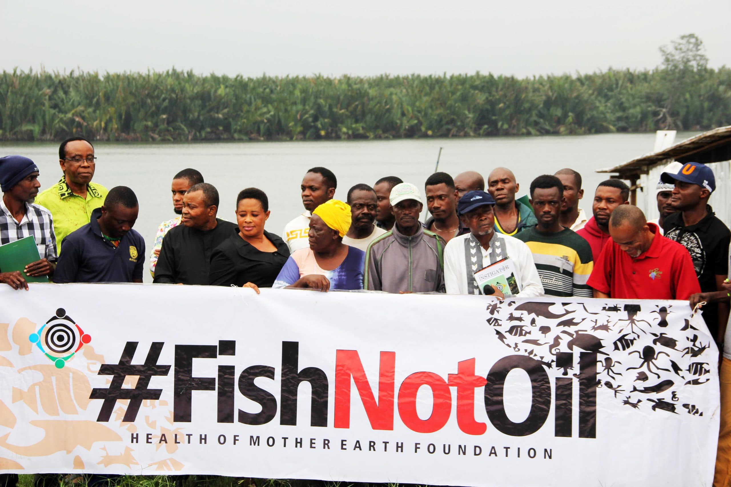 FishNet Alliance members with #FishNotOil banner